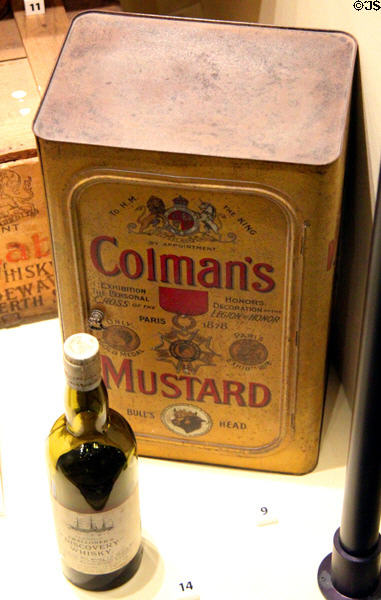 Colman's mustard tin & bottle of Discovery Whisky (1901) used on Antarctic expedition at RRS Discovery Museum. Dundee, Scotland.