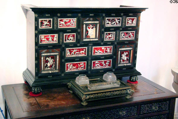 Cabinet decorated with hunting scenes plus inkwell set in king's bedroom at Glamis Castle. Angus, Scotland.