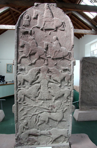 Pictish cross-slab (back of #2) with strips showing mounted huntsmen, warriors, Vanora execution scene (or Daniel in lion's den), centaur & beast biting ox at Meigle Sculptured Stone Museum. Meigle, Scotland.