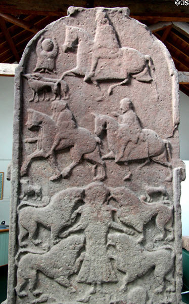 Pictish cross-slab (back of #2) with strips showing mounted huntsmen with dogs, mounted warriors, the Vanora execution by lions scene (or Daniel in lion's den) at Meigle Sculptured Stone Museum. Meigle, Scotland.