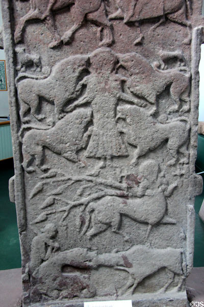 Pictish cross-slab (back of #2) detail with strips showing Vanora execution scene (or Daniel in lion's den), centaur, & beast biting ox head with man with club behind at Meigle Sculptured Stone Museum. Meigle, Scotland.