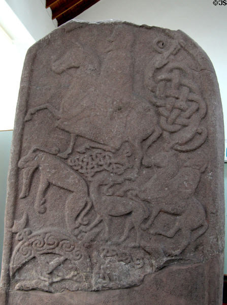 Pictish cross-slab (back of #4) with horseman over animals & swirled crescent at Meigle Sculptured Stone Museum. Meigle, Scotland.