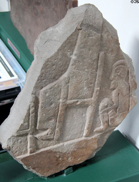 Pictish cross-slab (#27) shows servant sitting behind master's chair at Meigle Sculptured Stone Museum. Meigle, Scotland.