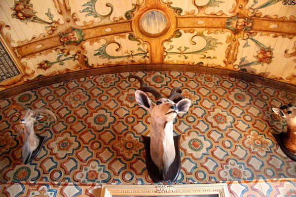 Trophy heads on wallpapered arch in Edwardian Library (1895) at Falkland Palace. Falkland, Scotland.