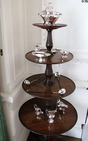 Round stack of tables with silver serving vessels at Hill of Tarvit Mansion. Cupar, Scotland.
