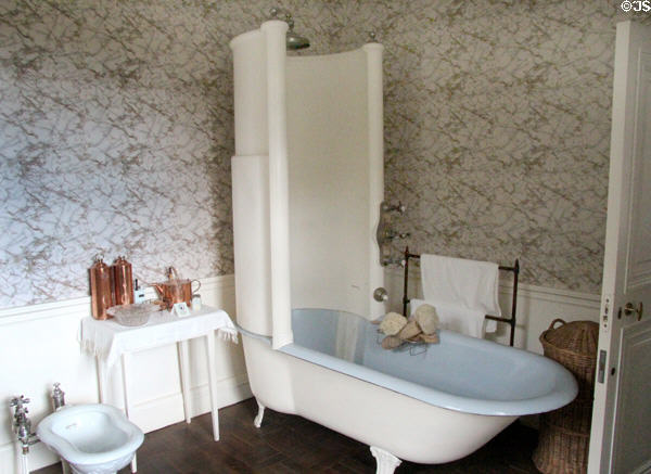 Bathroom with enclosing shower screen atop bathtub (early 20thC) at Hill of Tarvit Mansion. Cupar, Scotland.