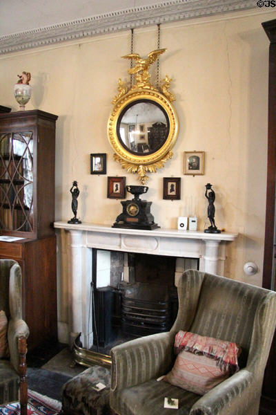 White marble chimneypiece with Regency convex mirror at Broughton House. Kirkcudbright, Scotland.