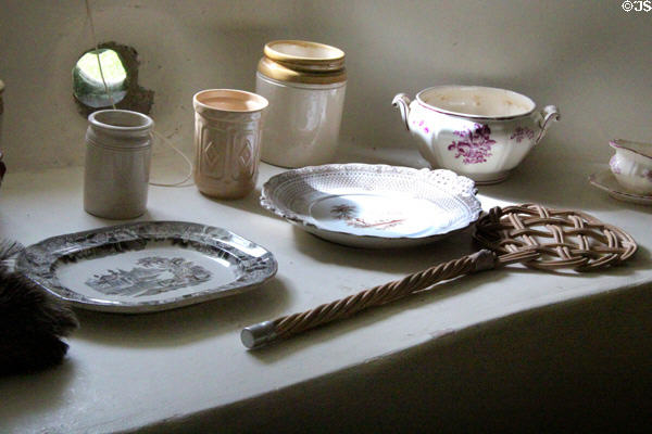Serving & storage dishes with rug beater at Castle Fraser. Aberdeenshire, Scotland.