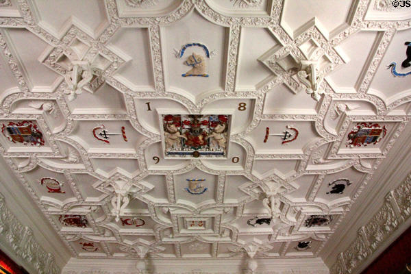 Sculpted plaster ceiling with crests & pendants (1890) in dining room at Fyvie Castle. Turriff, Scotland.