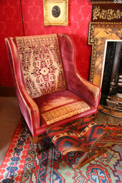 Armchair with footstool in library at Fyvie Castle. Turriff, Scotland.