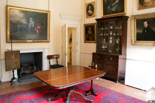 Lady Macduff's dressing room with table, display cabinet & paintings at Duff House. Banff, Scotland.