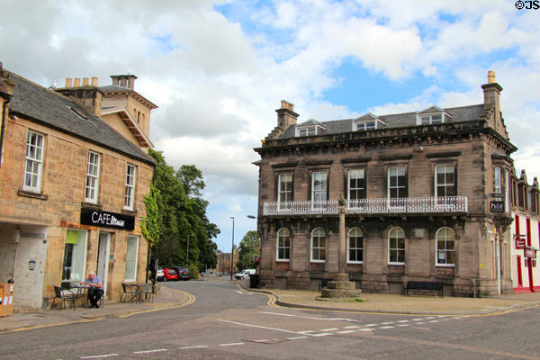Little cross (1733) on Elgin High Street flanked by heritage buildings. Elgin, Scotland.
