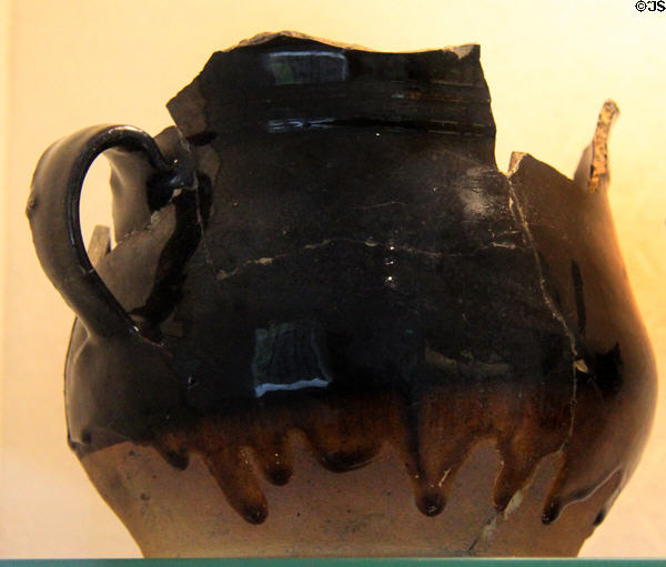 Black glazed earthenware pot with handle (mid-late 17thC - early 18thC) at Coalport China Museum. Ironbridge, England.