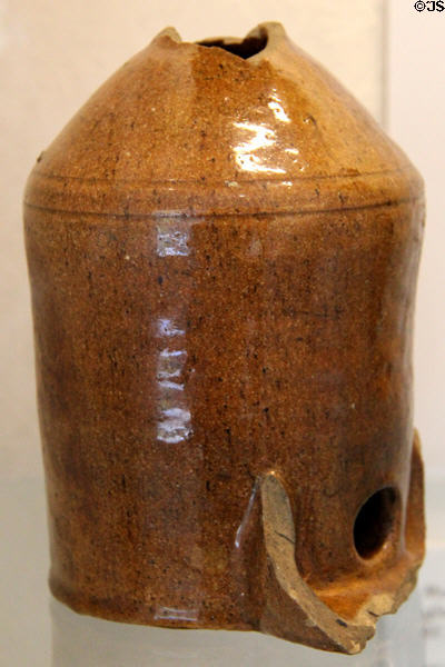 Brown glazed earthenware pot with shaped hole (c1600-1700) at Coalport China Museum. Ironbridge, England.