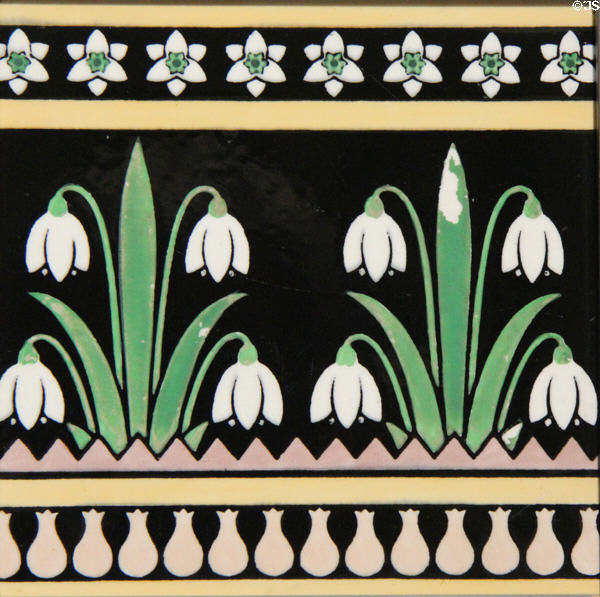 Transfer-printed tile with snowdrops (c1880) by A.W.N. Pugin made by Minton & Co at Jackfield Tile Museum. Ironbridge, England.