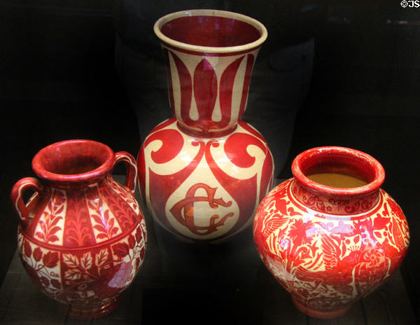 Three art pottery vases painted lustre red (c1890s) by Walter Crane for Maw & Co at Jackfield Tile Museum. Ironbridge, England.