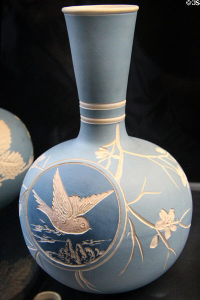 Salopian bottle vase incised with bird in flight in roundel on dark bluebackground (c1901-25) by Benthall Pottery at Jackfield Tile Museum. Ironbridge, England.