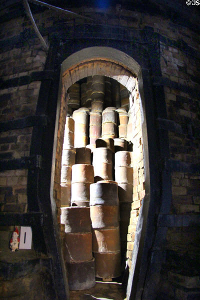 Saggars (essentially clay barrels) were used in kilns to support weight of wares being fired & protect new dishes from smoke at Gladstone Pottery Museum. Longton, Stoke, England.