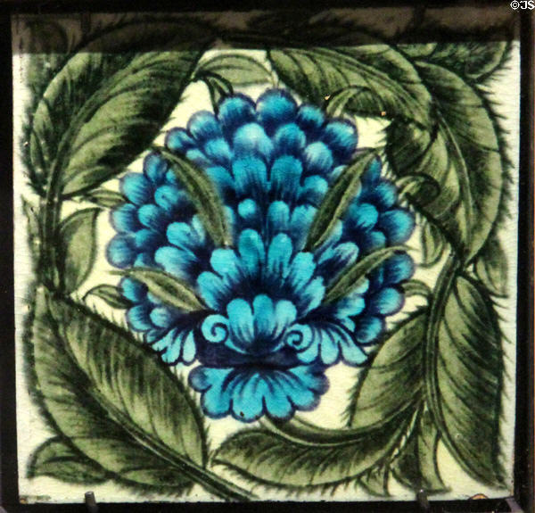 Blue flower tile (1887-97) by W De Morgan, Sands End at Gladstone Pottery Museum. Longton, Stoke, England.