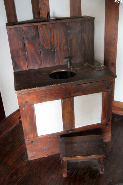 Replica of first flush Ajax water closet toilet (1594) invented by Sir John Harington & used by Queen Elizabeth I in bathroom history gallery at Gladstone Pottery Museum. Longton, Stoke, England.