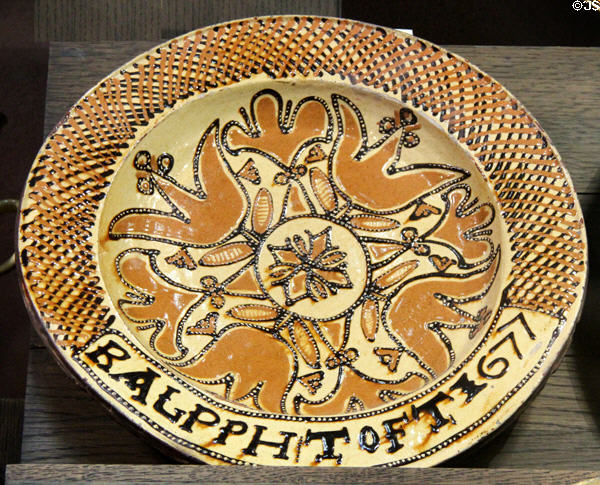 Slip decorated dish with tulip design (1677) by Ralph Toft of North Straffordshire at Potteries Museum & Art Gallery. Hanley, Stoke-on-Trent, England.