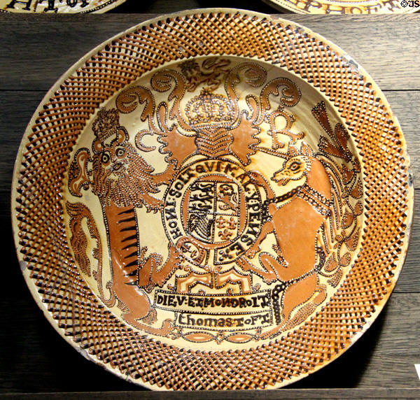 Slip decorated dish showing coat of arm of Charles II (c1670-75) by Thomas Toft of North Straffordshire at Potteries Museum & Art Gallery. Hanley, Stoke-on-Trent, England.
