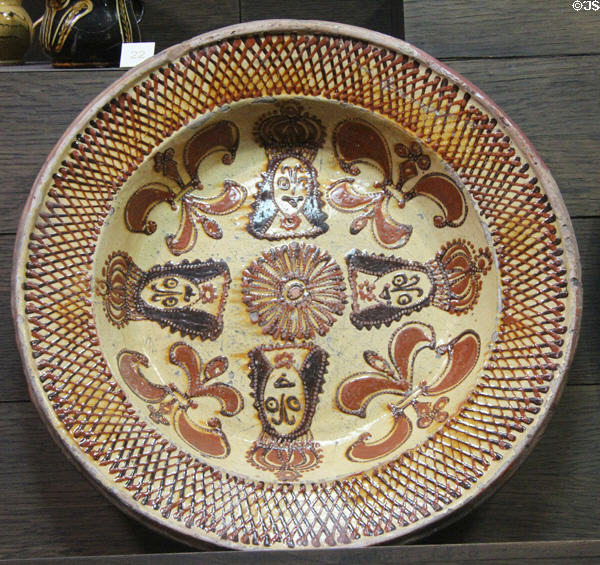 Slip decorated dish showing crowned heads of restoration (c1685-1700) made in North Straffordshire at Potteries Museum & Art Gallery. Hanley, Stoke-on-Trent, England.