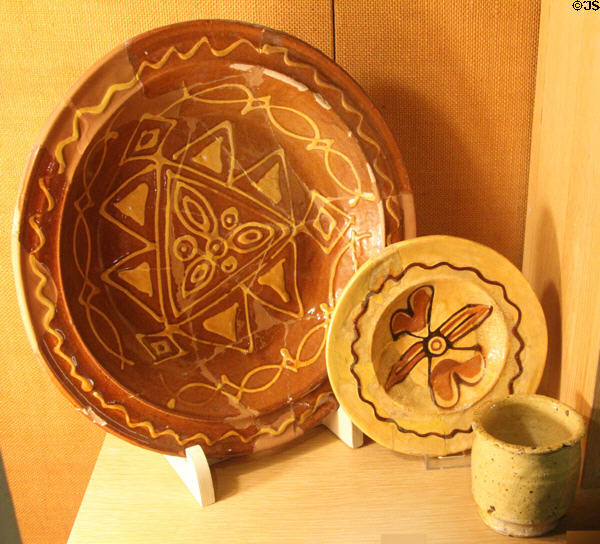 Slipware dishes with transparent yellowy lead glaze (c1680-1720) excavated in Burslem, Stoke at Potteries Museum & Art Gallery. Hanley, Stoke-on-Trent, England.