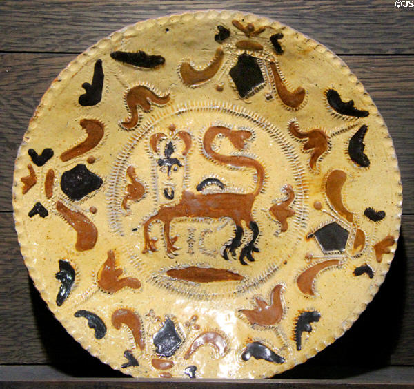 Slip decorated dish with crowned lion (1700-20) by potter with initials IG made in North Straffordshire at Potteries Museum & Art Gallery. Hanley, Stoke-on-Trent, England.