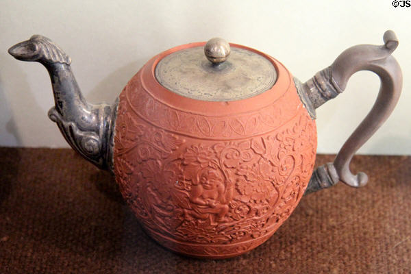 Red earthenware thrown teapot with carved decoration (17thC) from Yixing, China at Potteries Museum & Art Gallery. Hanley, Stoke-on-Trent, England.