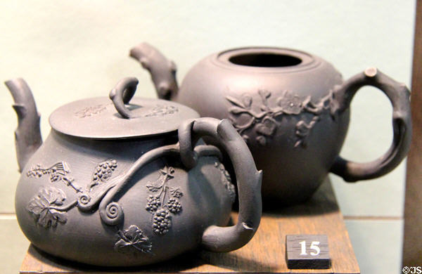 Black basalt teapot with flower prays applied (c1760-70) probably by Thomas & John Wedgwood (cousins of Josiah) of Burslem, Staffordshire at Potteries Museum & Art Gallery. Hanley, Stoke-on-Trent, England.