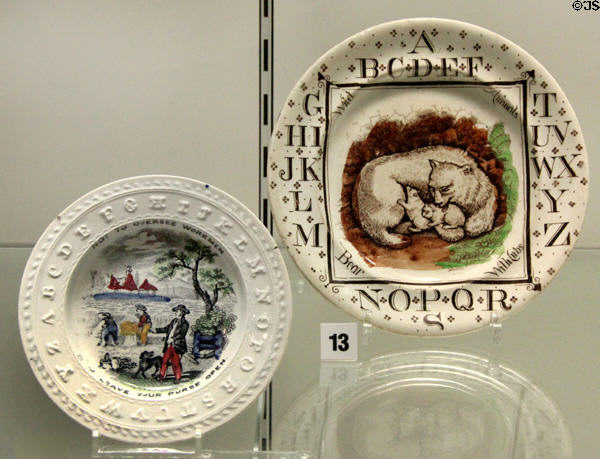Creamware alphabet plates for children (r) (c1809-34) prob. by T&B Godwin of Longport & (l) (c1882) by Brownhills Pottery Co. of Tunstall, Staffordshire at Potteries Museum & Art Gallery. Hanley, Stoke-on-Trent, England.