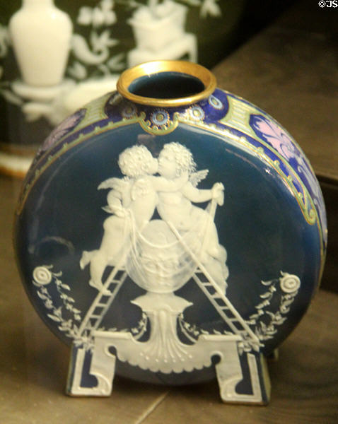 Porcelain flask with applied cupids (1870s-90s) by M.L. Solon for Mintons of Stoke-upon-Trent at Potteries Museum & Art Gallery. Hanley, Stoke-on-Trent, England.