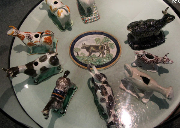 Variety of cow cream jugs commonly used to serve fresh cream at tea table at Potteries Museum & Art Gallery. Hanley, Stoke-on-Trent, England.