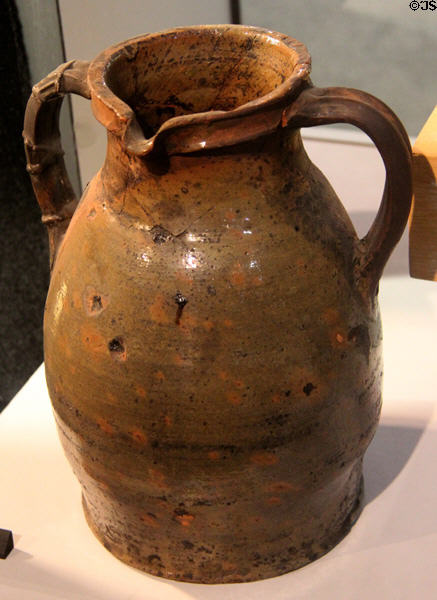 Red earthenware two handled jar with greenish glaze (13thC) from Cambridge at Potteries Museum & Art Gallery. Hanley, Stoke-on-Trent, England.