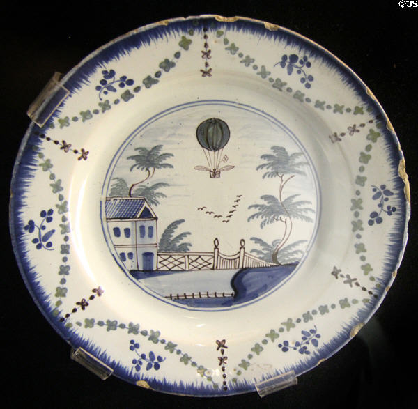 Tin-glazed earthenware plate painted with balloon ascent (c1784-5) made in Lambeth, London at Potteries Museum & Art Gallery. Hanley, Stoke-on-Trent, England.