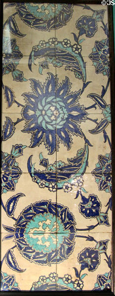 Twelve-tile panel painted with carnations & ribbons (c1880s) by William de Morgan at Potteries Museum & Art Gallery. Hanley, Stoke-on-Trent, England.