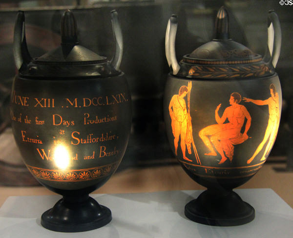 Black Basalt vases with red encaustic decoration of classical figures noting First Day of production on reverse (June 13, 1769) by Wedgwood at World of Wedgwood. Barlaston, Stoke, England.
