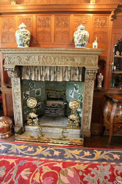 Carved alabaster Italian Renaissance fireplace surround (c1600) from Venice integrated (1888) with Arts & Crafts fireplace parts in drawing room at Wightwick Manor. Wolverhampton, England.