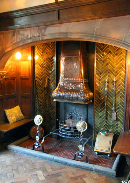 Lower hall fireplace with several elements including the copper canopy possibly from Morris & Co at Wightwick Manor. Wolverhampton, England.