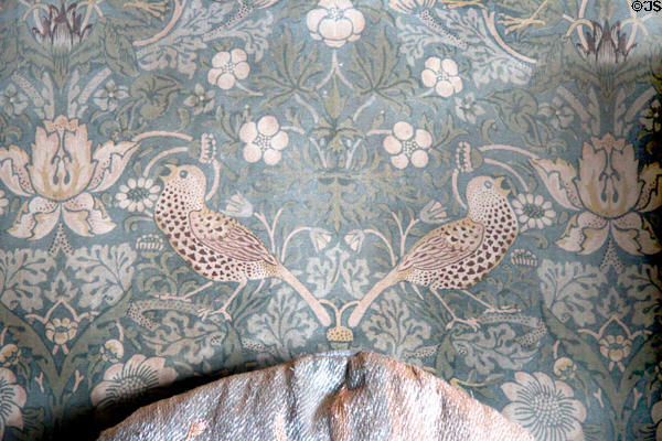 Detail of Strawberry Thief fabric on wing-back armchair (c1890) by Morris & Co at Wightwick Manor. Wolverhampton, England.