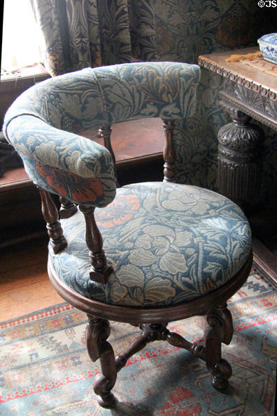 Tulip & Rose woven wool fabric by Morris & Co on padded round revolving desk chair in Great Parlor at Wightwick Manor. Wolverhampton, England.