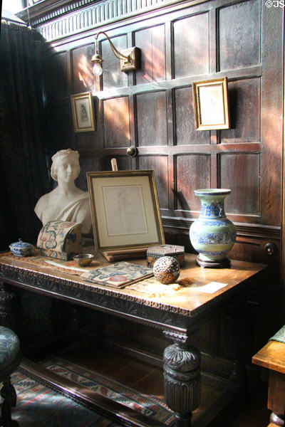 Tudor table holding a number of Victorian decorative arts pieces at Wightwick Manor. Wolverhampton, England.