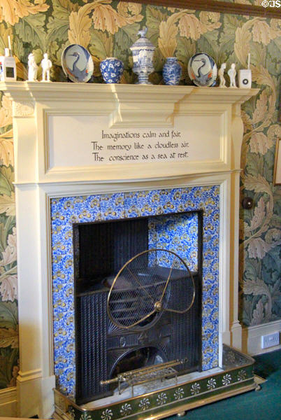 Arts & Crafts style fireplace with printed poem surrounded by Acanthus wallpaper (1875) by William Morris at Wightwick Manor. Wolverhampton, England.