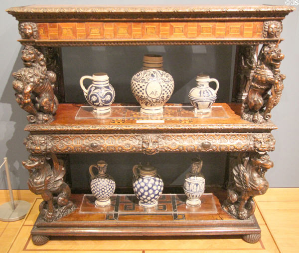 English court cupboard (c1606) holding salt-glazed stoneware jugs & tankards (c1600-1720) by Westerwald & Raeren of Germany at Ashmolean Museum. Oxford, England.