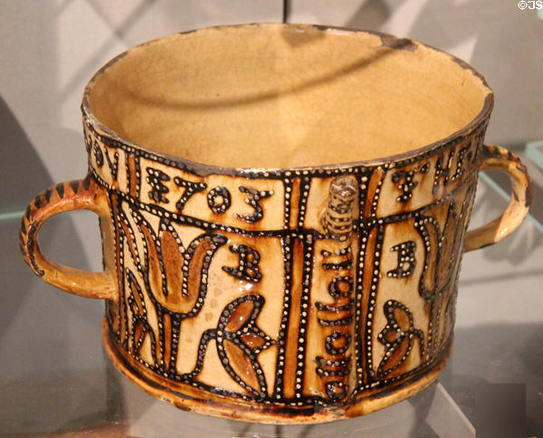 Earthenware posset pot (1703) from Staffordshire, England at Ashmolean Museum. Oxford, England.