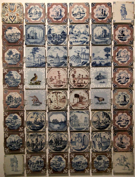 English & Dutch delftware c tile collection (early 16thC) painted with designs which originated in Delft, Holland but soon copied by English makers at Ashmolean Museum. Oxford, England.