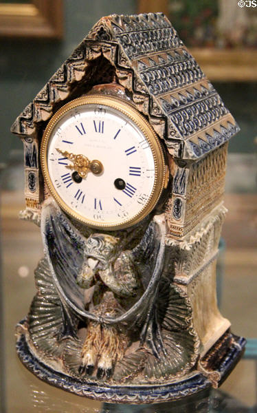 Salt glazed stoneware mantel clock supported by bat (1876) by Martin Brothers of Fulham at Ashmolean Museum. Oxford, England.