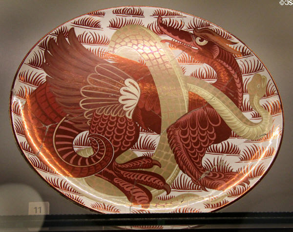 Ruby lustre plus gold dragon & snake plate (1872-1907) by William De Morgan at Ashmolean Museum. Oxford, England.