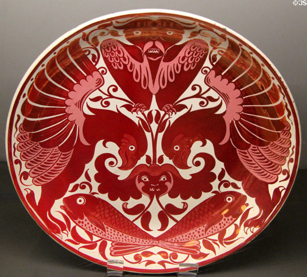 Ruby lustre eagle, owl & fish dish (1872-1907) by William De Morgan at Ashmolean Museum. Oxford, England.